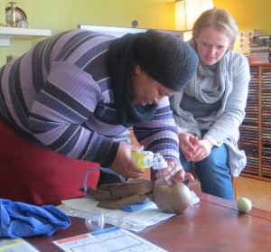 Claire watches while Jabu positions the baby's head correctly